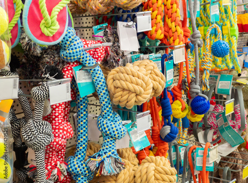 Pet care concept, various pet accessories and tools, toys, balls, brushes in a pet store, shelves with accessories.