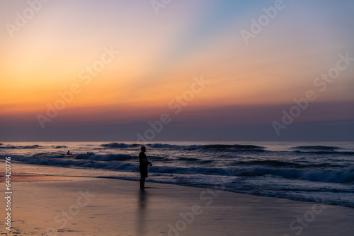 Surfcaster on the Beach before the Sunrise