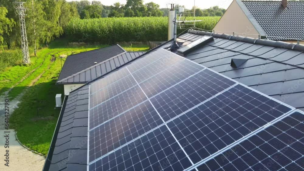 Aerial view to new modern solar panels on the roof of a luxury house, alternative energy source for home, green energy from the sun, industrial concept