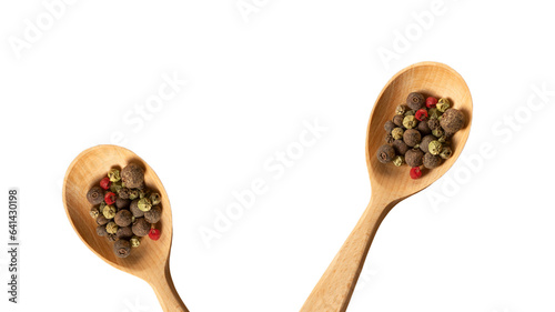 New wooden spoons with mixture of dry round hot red pepper, black pepper, white pepper, green pepper isolated on white background, for design