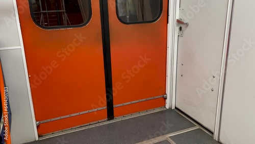 closing the doors of the train in the subway. orange old vintage doors