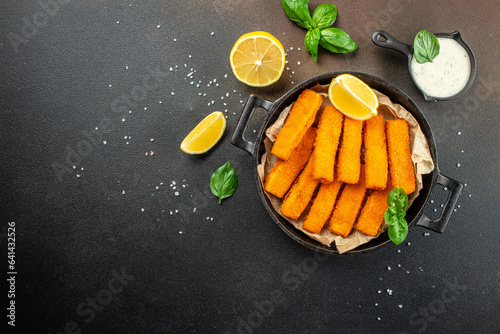 Fish fingers sticks on a dark background. banner, menu, recipe place for text, top view