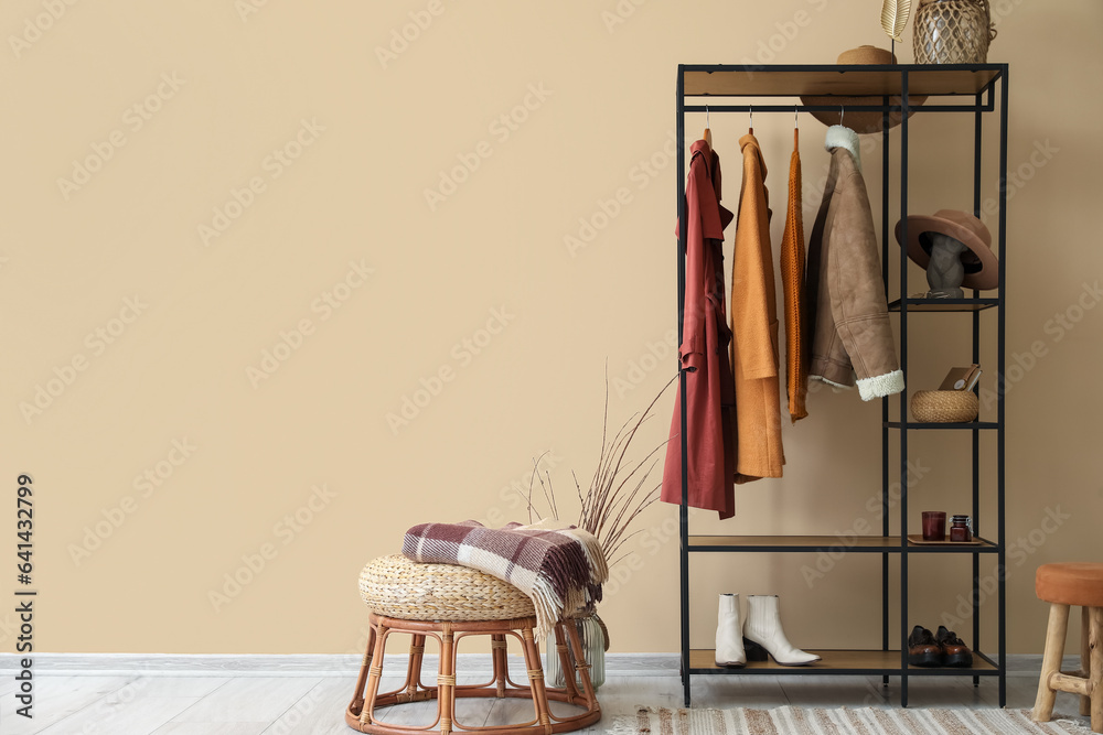 Interior of hall with shelving unit, clothes and shoes