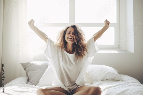 happy beautiful woman stretching arms in the morning after sleep