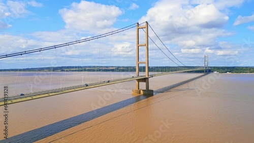 Aerial drone view of Humber Bridge, 12th largest suspension span, gracefully crossing River Humber, connecting Lincolnshire to Humberside with traffic.