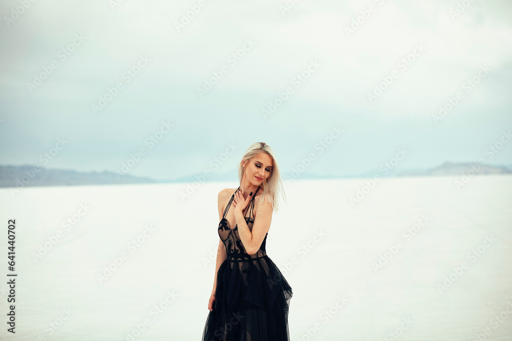 Beautiful Blonde Women Posing in Black Dress At Utah Salt Flats Beautiful Blonde Women Posing in Black Dress At Utah Salt Flats
