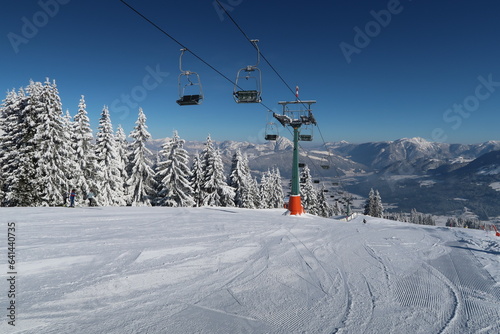 Ski lift on a snowy mountain in the alps photo