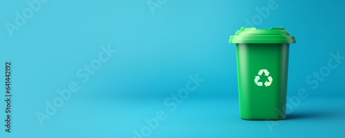 Fotografiet Green plastic recycle bin eco banner with copy space isolated on blue background
