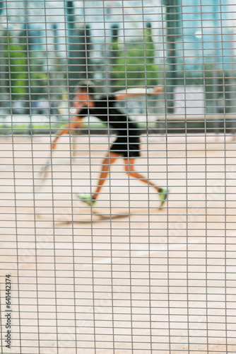 Young man playing tennis on court. Sport summer concept. Blurred background