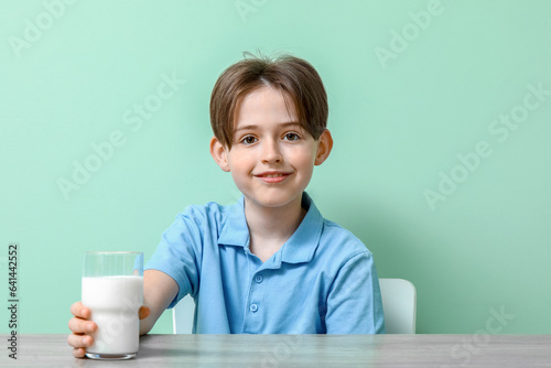 Happy little boy sitting at...