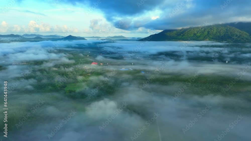 Sunrise light blankets the lush tropical forest and verdant plantations with a delicate veil of ethereal fog, creating a breathtaking scene. Aerial drone view captures nature's mystique. Thailand
Sunrise light blankets the lush tropical forest and verdant plantations with a delicate veil of ethereal fog, creating a breathtaking scene. Aerial drone view captures nature's mystique. Thailand