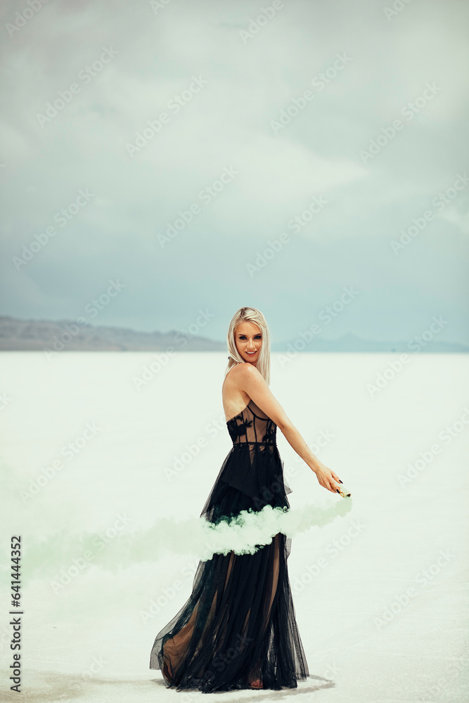 Beautiful blonde woman in a black dress at the Utah Salt Flats Beautiful blonde woman in a black dress at the Utah Salt Flats