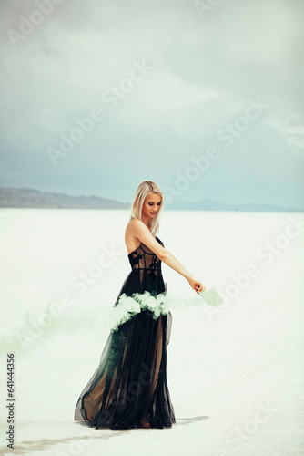 Beautiful blonde woman in a black dress at the Utah Salt Flats