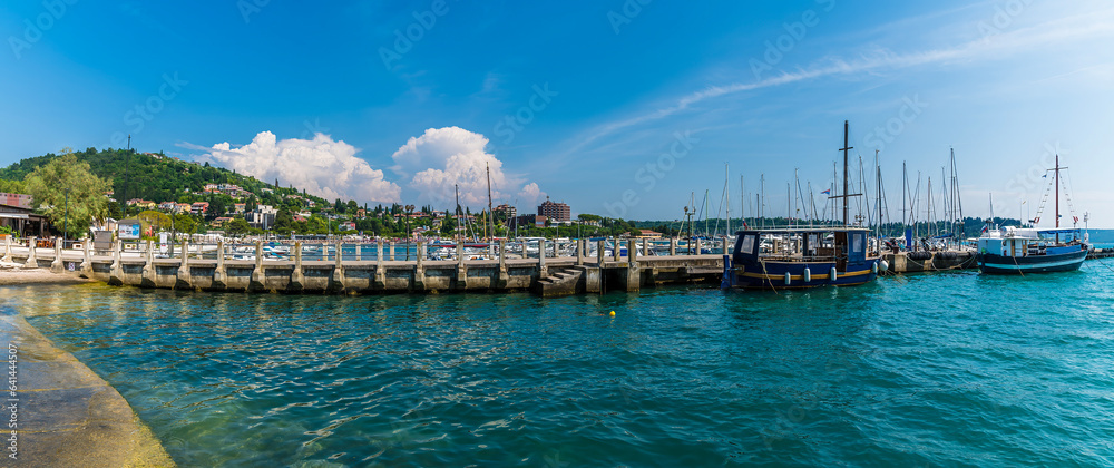 A panorama view past boats moored on a jetty at Portoroz, Slovenia in summertime