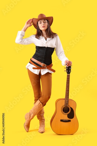 Beautiful cowgirl with guit...