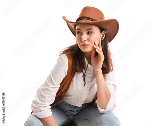 Beautiful cowgirl sitting o...
