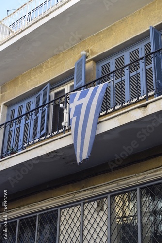 Greek flag flying on the balcony.