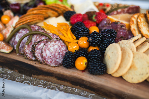 Charcuterie board with cheeses, grapes, blackberries, crackers and salami