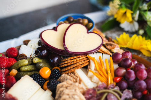 Charcuterie board with cheeses, grapes, crackers and salami