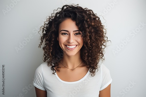 Beautiful girl with curly hair smiling.