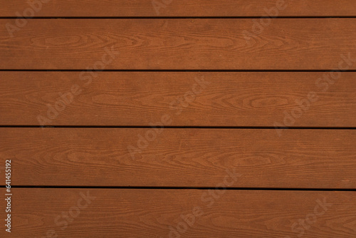 Abstract background, natural wood veneer, dark brown panel appearance, shot from a high angle, can be used as a backdrop or wallpaper.