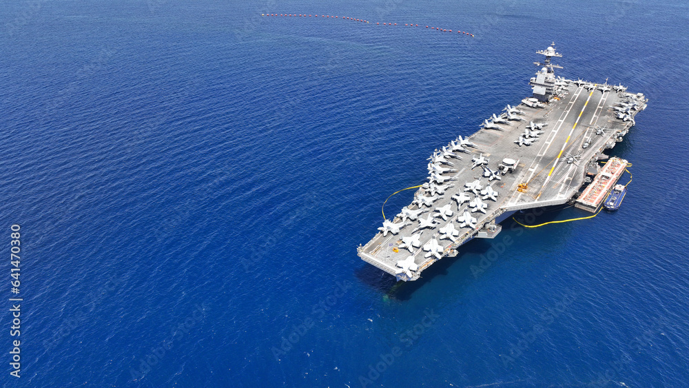 Aerial drone photo of latest technology American USS Gerald R. Ford nuclear aircraft carrier anchored in deep blue sea