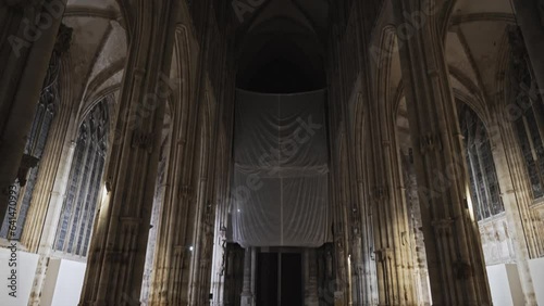 Rouen, France - 20 08 2023: Interior part of the Saint-Ouen cathedral in the evening. Huge gothic church with tall columns and the famous organ in the centre, covered for restoration.