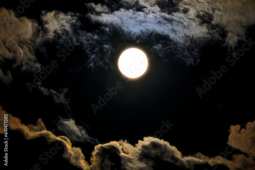 Beautiful full moon with clouds on a dark summer night. Photo taken August 30th, 2023, Zurich, Switzerland.