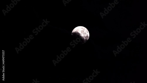 Beautiful full moon with clouds on a dark summer night. Movie shot August 30th, 2023, Zurich, Switzerland.