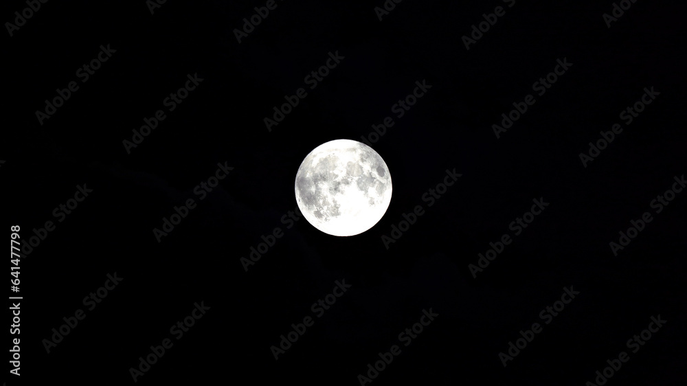 Beautiful full moon with clouds and craters on a dark summer night. Photo taken August 30th, 2023, Zurich, Switzerland. Beautiful full moon with clouds and craters on a dark summer night. Photo taken August 30th, 2023, Zurich, Switzerland.