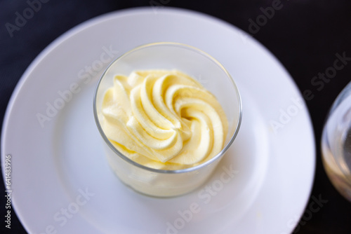 Sweet dessert of lemon sorbet served in glass with necessary table laying