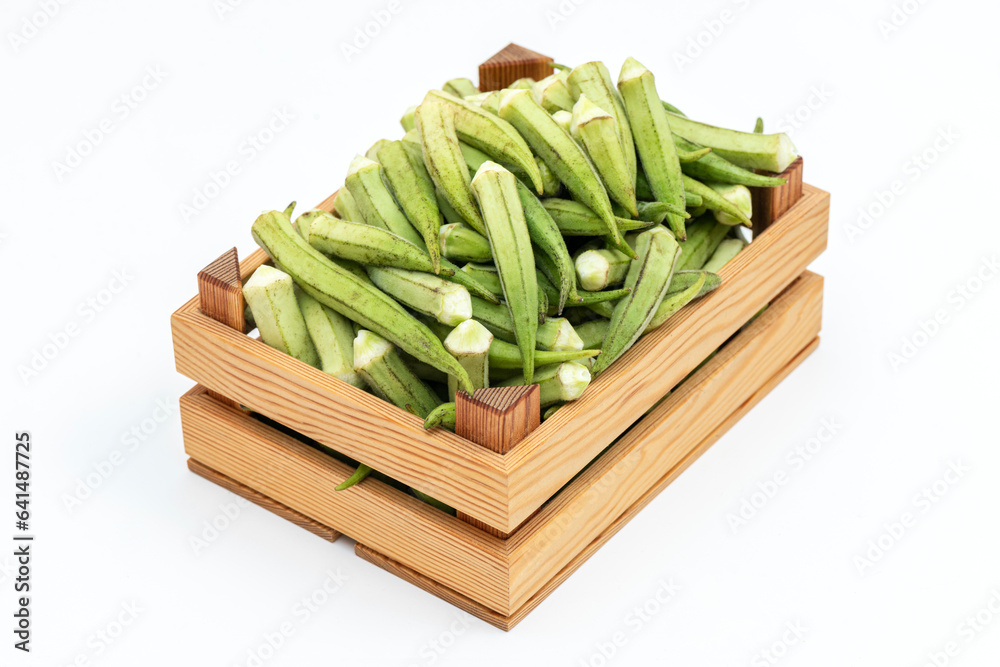 Fresh okra on the wooden container.