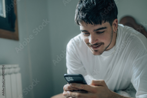 young man with mobile phone at home