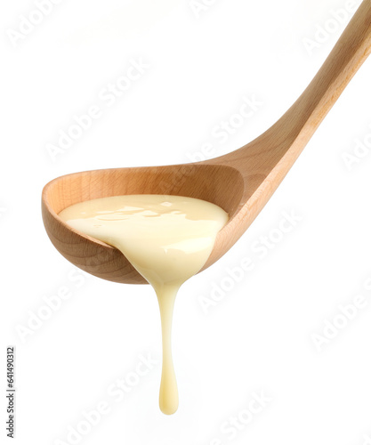 condensed milk in wooden ladle