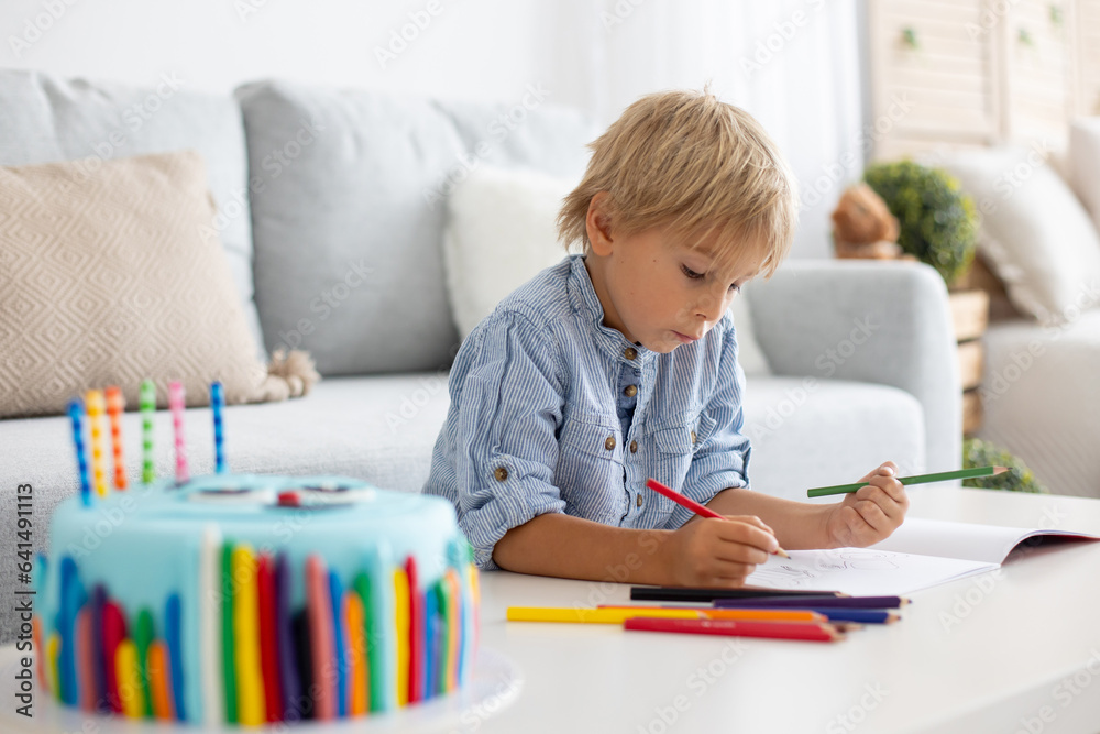 Cute preschool child, blowing candles on his cake, six years old, going to school. Cute preschool child, blowing candles on his cake, six years old, going to school.