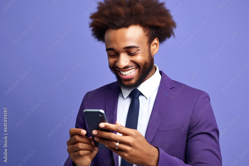 Man dressed in purple suit is smiling as he looks at his cell phone. This picture can be used to represent modern technology and communication. Man dressed in purple suit is smiling as he looks at his cell phone. This picture can be used to represent modern technology and communication.