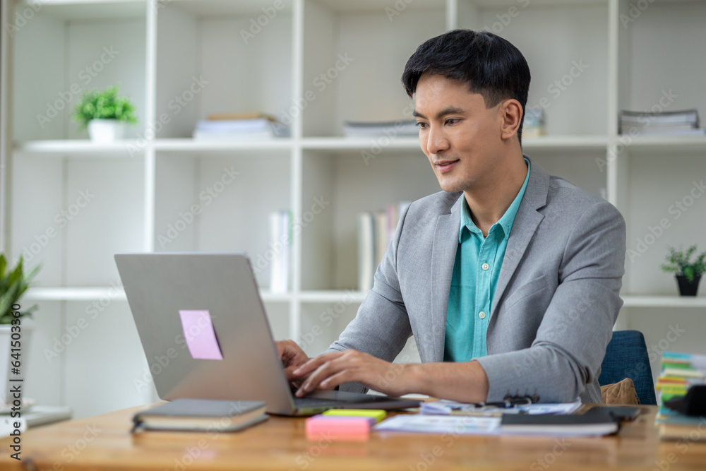 Asian man in corporate office, businessman who owns a startup company sits in office, professional executive runs a company, managing the business to grow and make a profit. Company executives' ideas. Asian man in corporate office, businessman who owns a startup company sits in office, professional executive runs a company, managing the business to grow and make a profit. Company executives' ideas.
