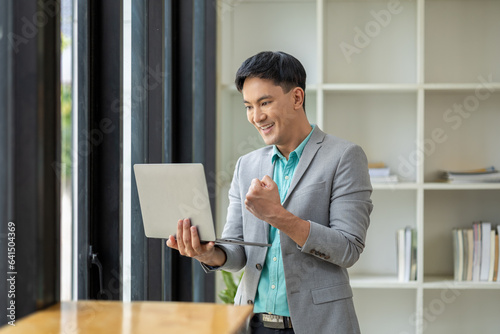 Asian man in corporate office, startup owner businessman working in office, corporate executive running professional, growing and profitable business. Company executives' ideas.