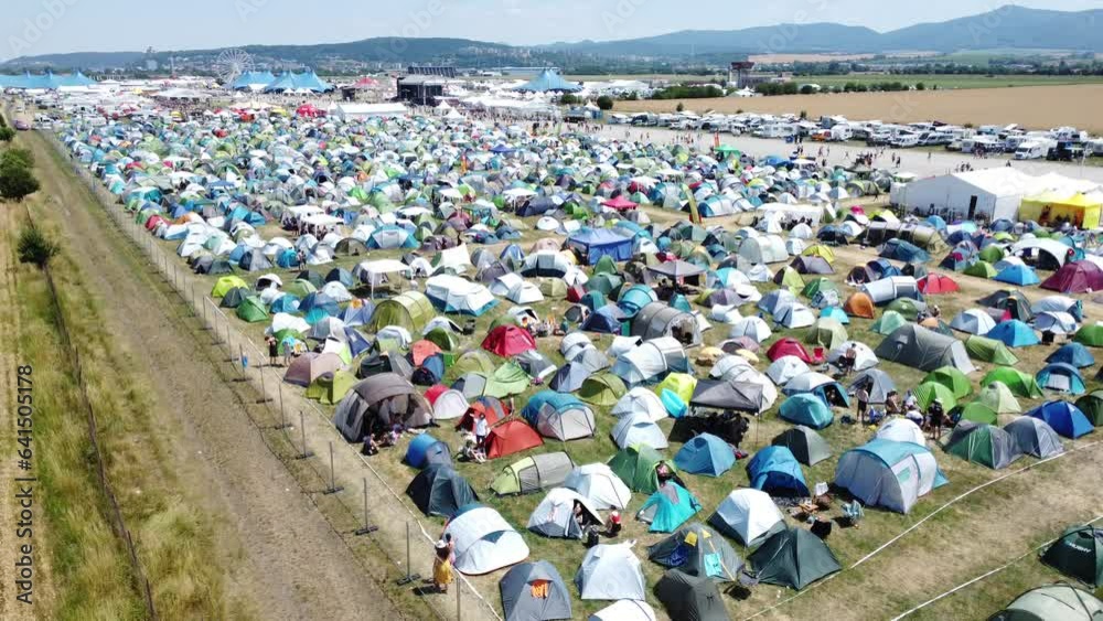 Pohoda Musical Festival 2023 in Slovakia filled with tents and cars in parking lot aerial shot by drone day