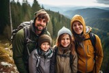 Smiling portrait of a young caucasian family hiking in the forests and mountains
