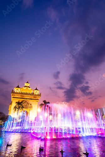 Water fountain and multi colored lightshow, at sunset,next to Patuxai monument in Vientiane, Laos.