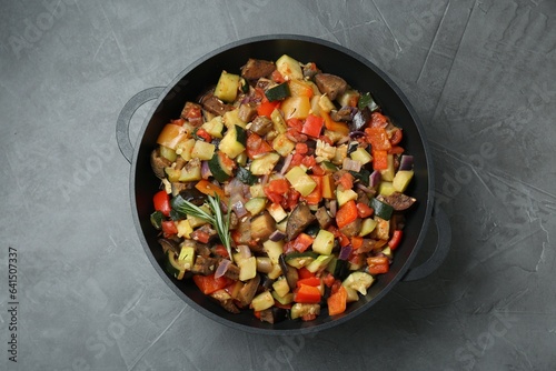 Delicious ratatouille in baking dish on grey table, top view