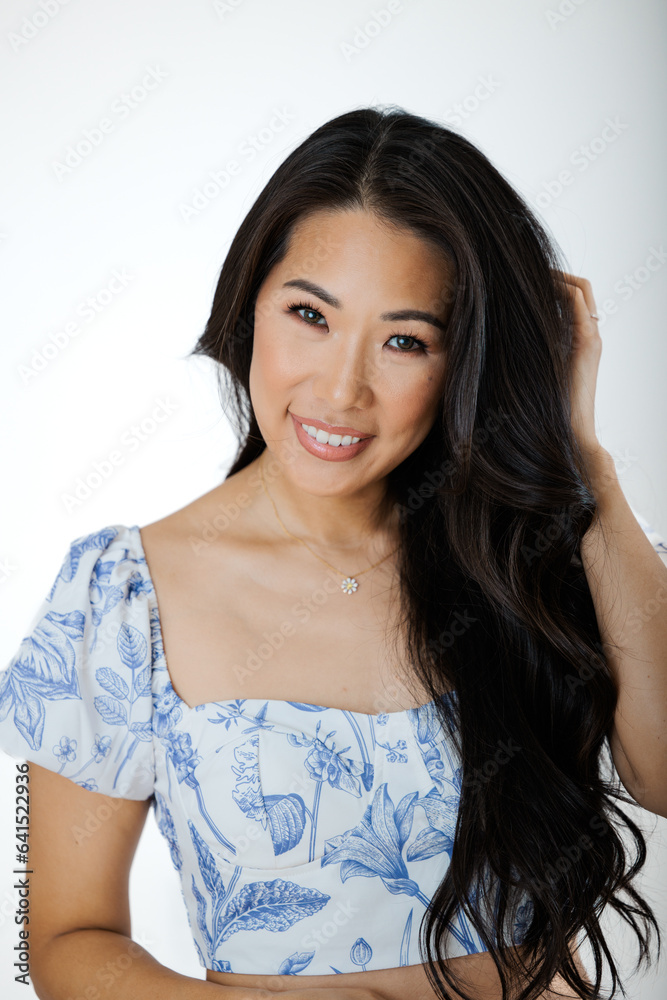 Asian young woman in summer dress against white background Asian young woman in summer dress against white background