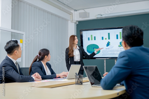 Office Conference Business Meeting Presentation: asian Business people group meeting Talks, Uses Wall TV to Show Company Growth with Big Data Analysis, Graphs, Charts, Infographics, e-Commerce Startup © maya1313