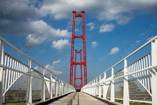 Kumala Island Red Bridge which is access to one of the tourist destinations in Tenggarong City, Kutai Kartanegara Regency, namely Kumala Island. photo