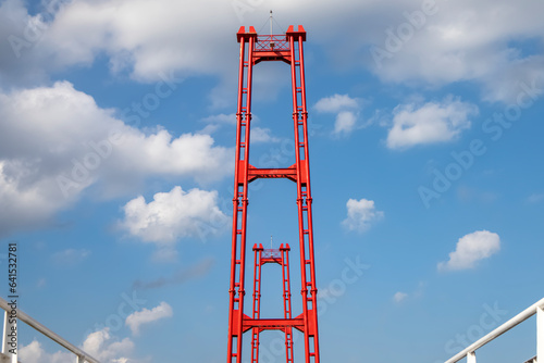Kumala Island Red Bridge which is access to one of the tourist destinations in Tenggarong City, Kutai Kartanegara Regency, namely Kumala Island. photo