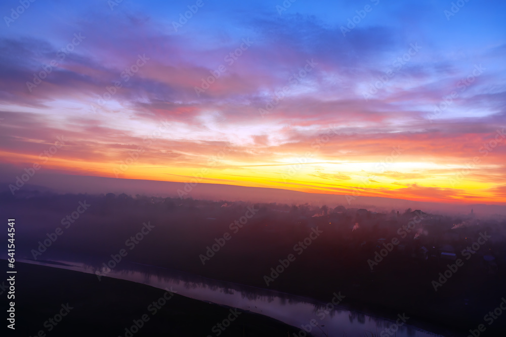 Aerial view of a foggy sunrise over the river