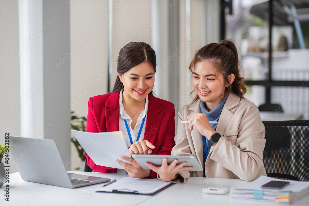 Two business women are discussing and exchanging knowledge on graphs and finance data. Two business women are discussing and exchanging knowledge on graphs and finance data.