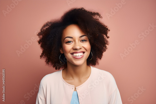 portrait of black woman smiling in a studio, plain colour background