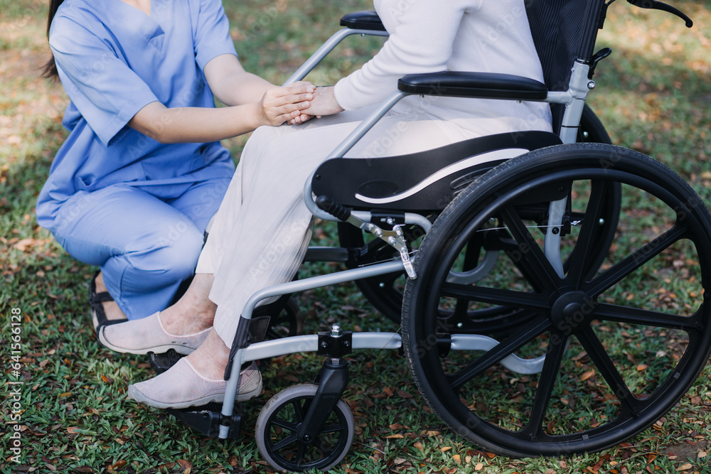 Obraz premium Asian young woman nurse at nursing home take care disabled senior man. Caregiver doctor serve physical therapy for older elderly patient to exercise and practice walking on walker or cane at backyard.